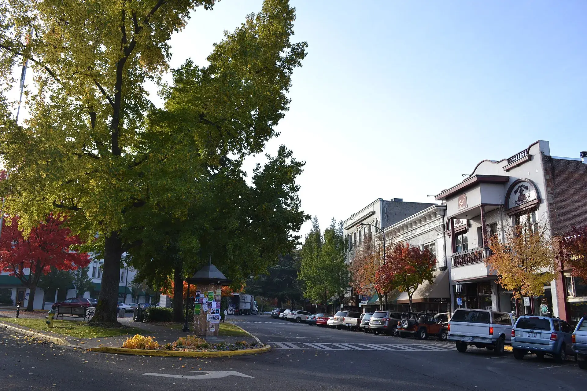 Downtown Ashland, Oregon in autumn, with historic storefronts and turning trees
